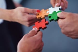 Group of business people assembling jigsaw puzzle